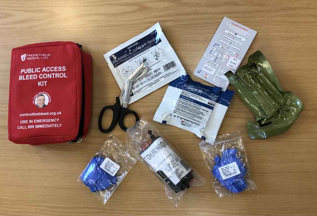 Red bleed control kit with contents including scissors and tourniquets