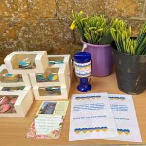 Cupcakes, donations, daffodils and flyers on a table